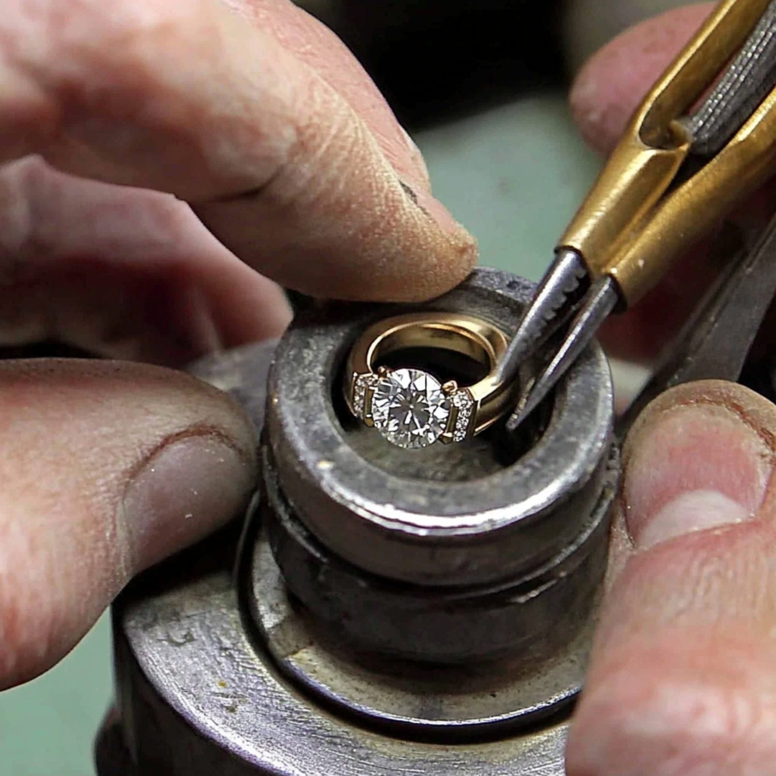 Jeweler setting a diamond by hand