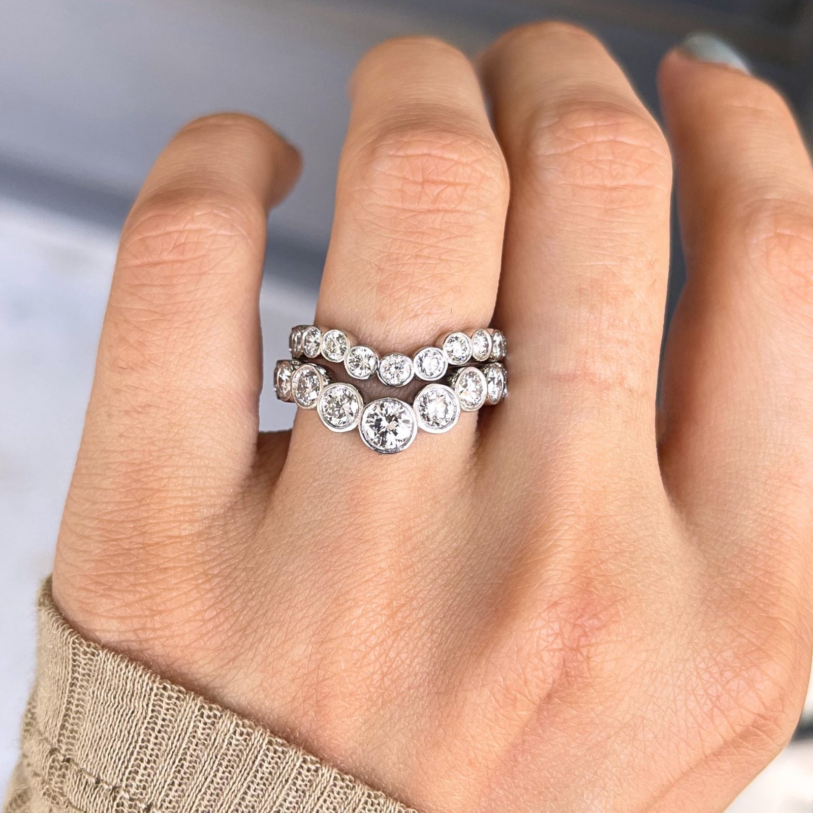 The New Heirloom — two bezel-set diamond eternity bands stacked on a hand